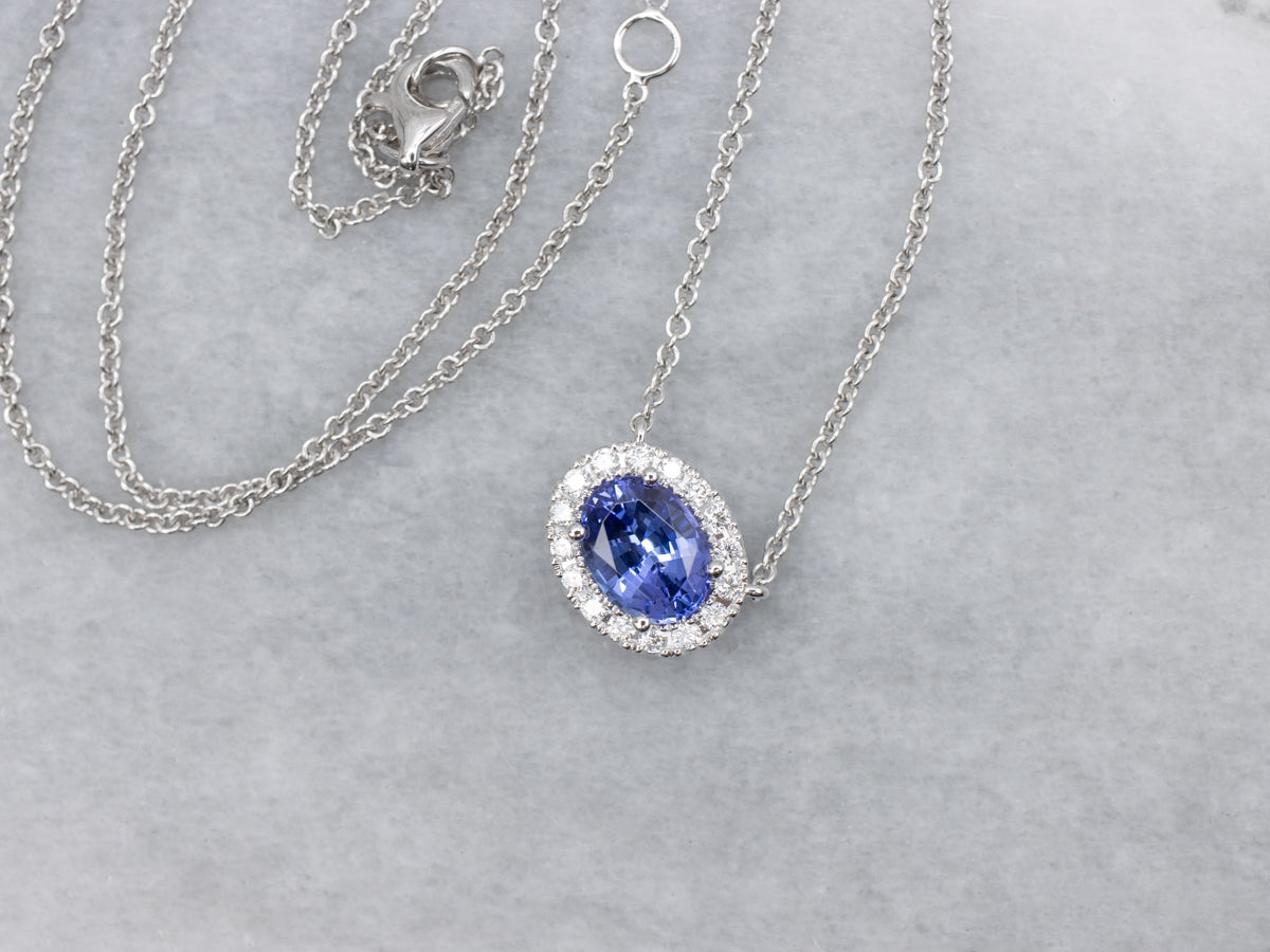 Modern East-to-West Set Tanzanite and Diamond Halo Pendant Necklace