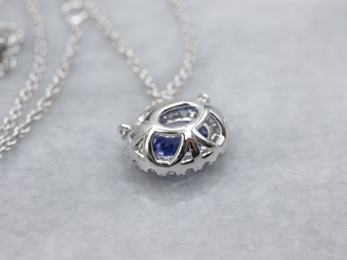 Modern East-to-West Set Tanzanite and Diamond Halo Pendant Necklace