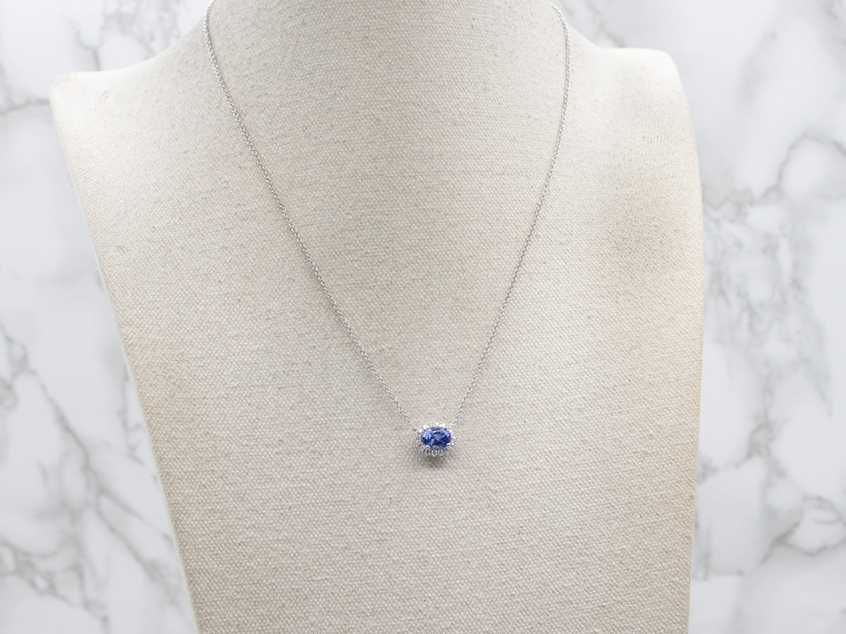 Modern East-to-West Set Tanzanite and Diamond Halo Pendant Necklace