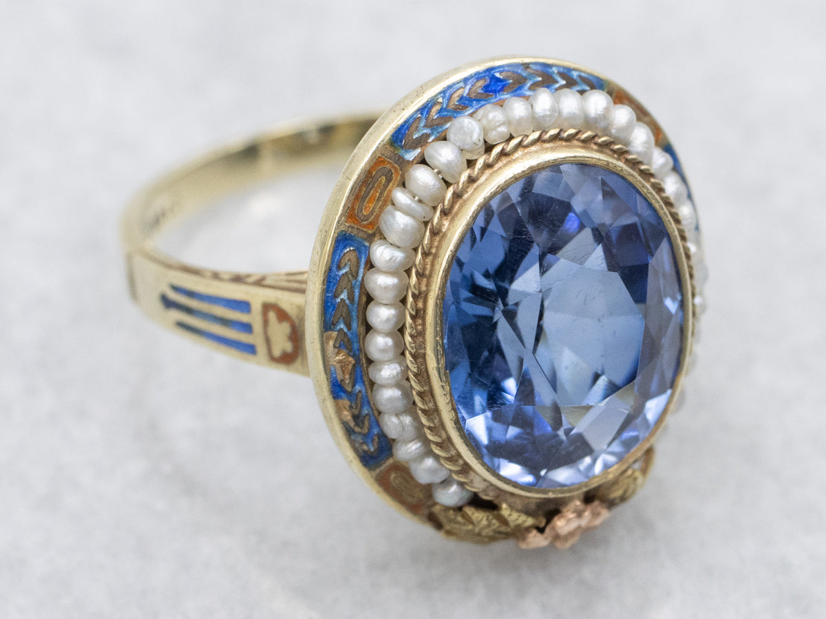 Art Nouveau Era Synthetic Sapphire with Seed Pearl Halo and Blue Enamel Ring