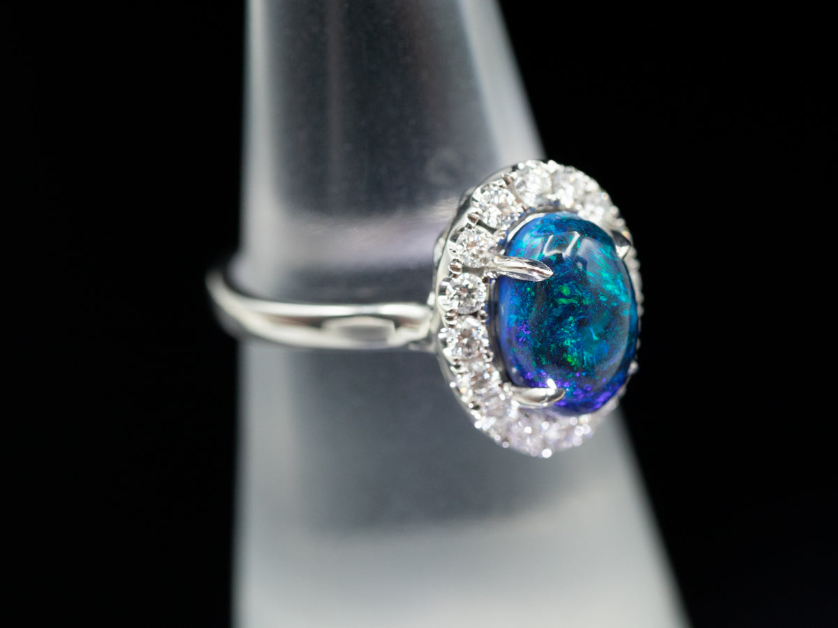 18K White Gold Black Opal Oval and Diamond Halo Ring