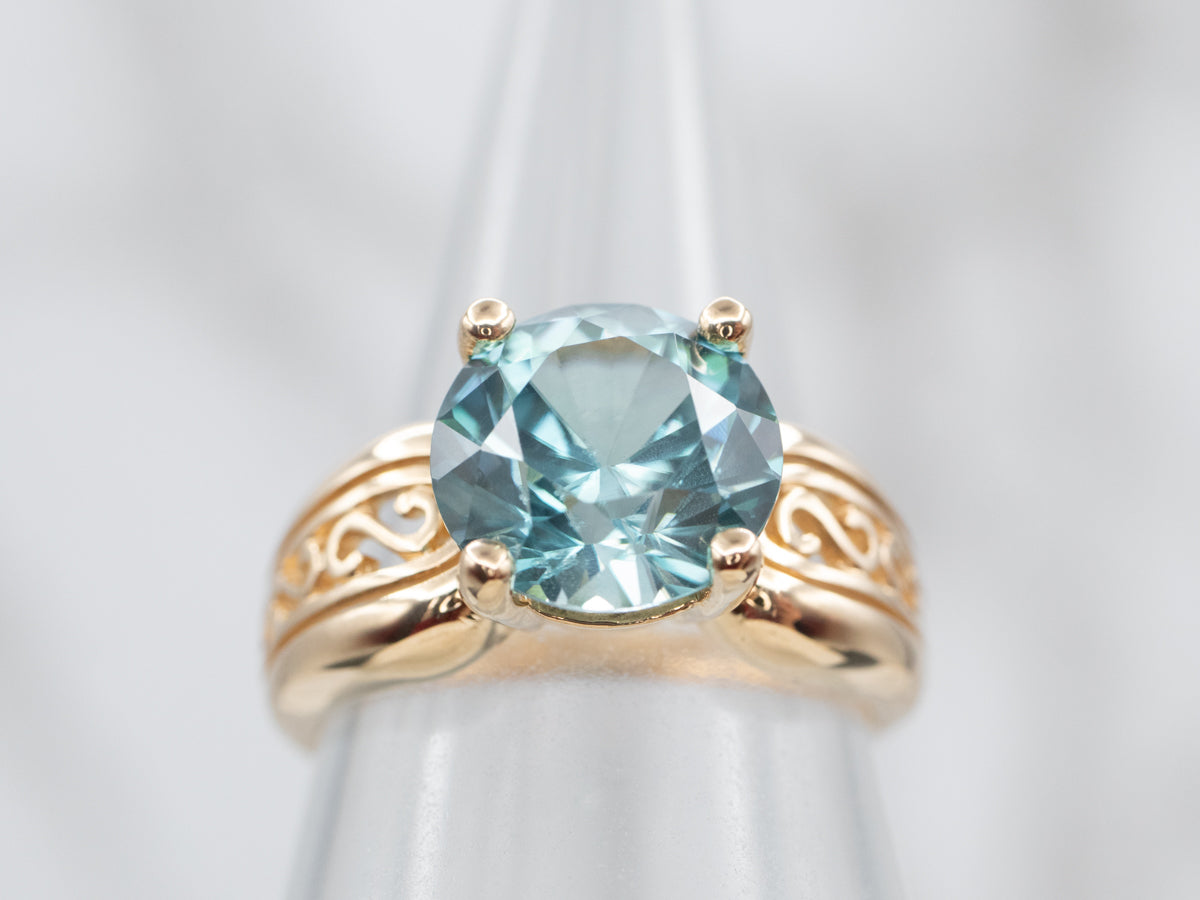 Yellow Gold Blue Zircon Solitaire Ring with Filigree Shoulders