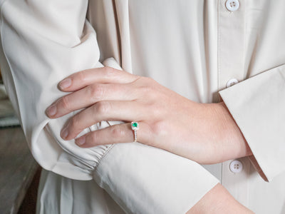 Modern Emerald and Diamond Halo Engagement Ring