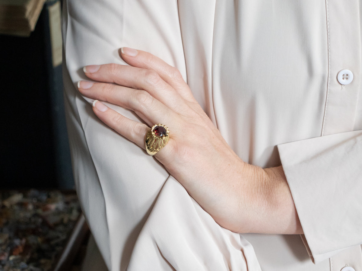 Anillo de oro amarillo con granate adornado