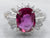 Platinum Oval Cut Ruby with Baguette and Round Cut Diamond Halo