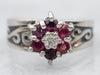 White Gold Ruby and Diamond Flower Ring with Diamond Accent and Swirling Shoulders