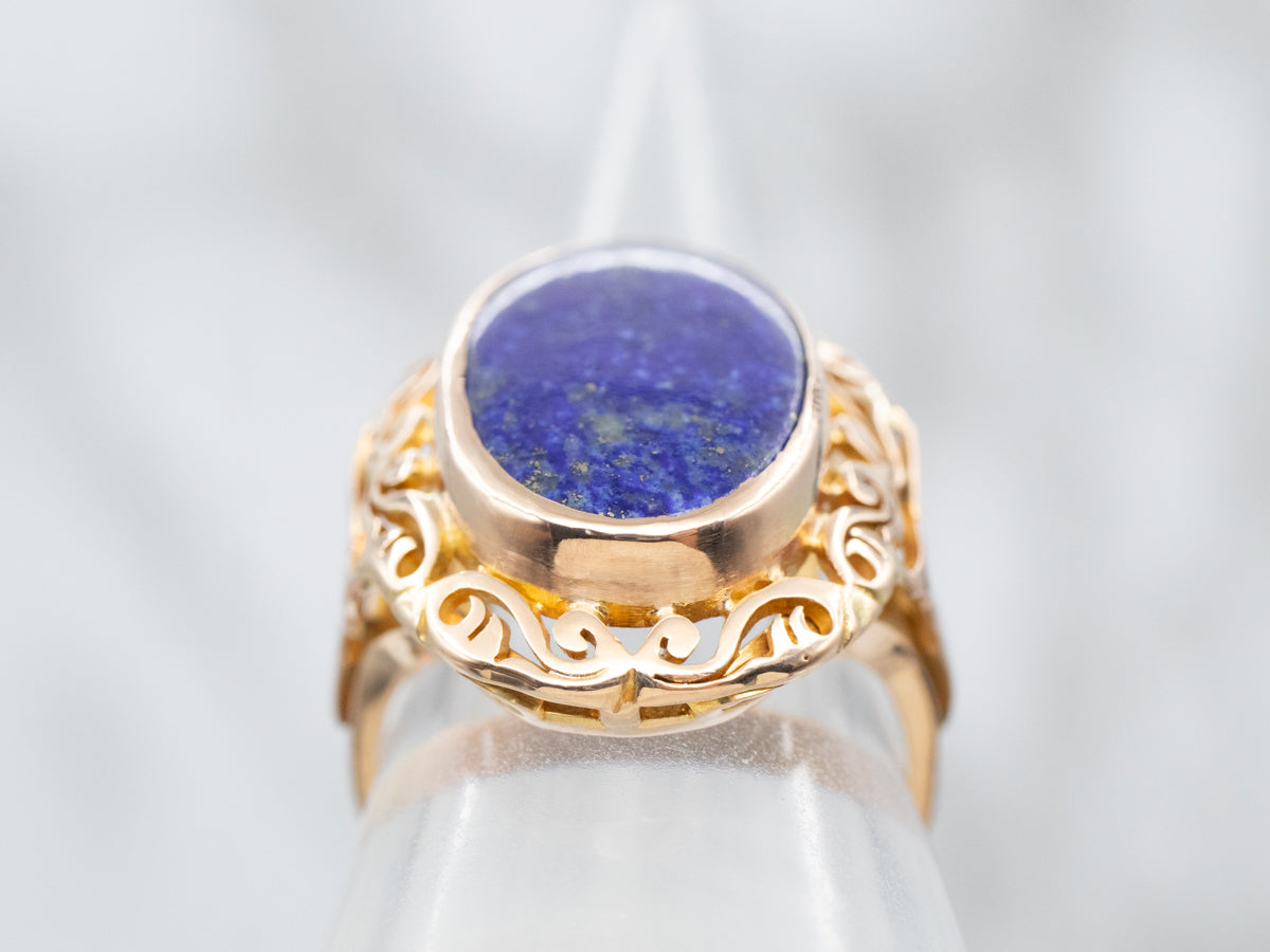 Yellow Gold Bezel Set Oval Cut Lapis Ring With Scrolling Frame