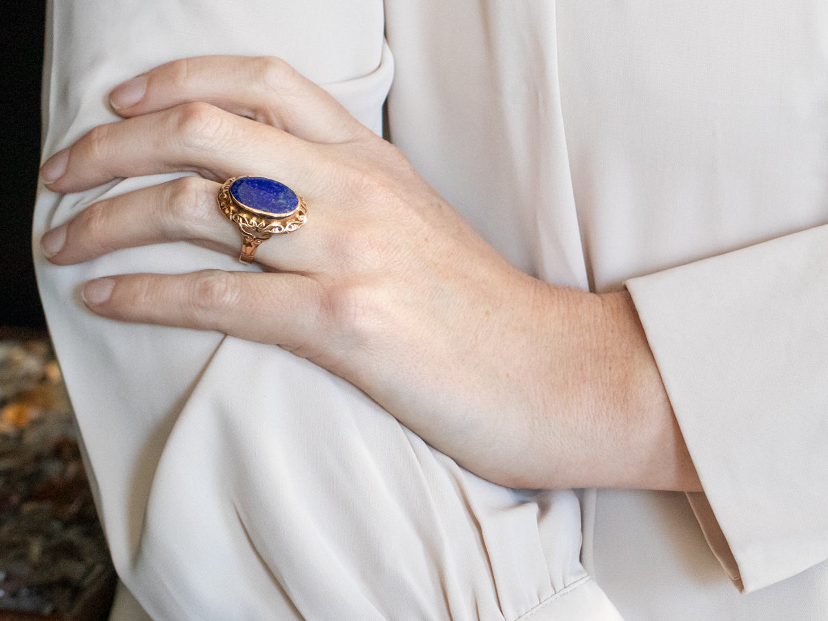Yellow Gold Bezel Set Oval Cut Lapis Ring With Scrolling Frame