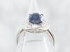Platinum Oval Cut Sapphire Engagement Ring with Round and Baguette Cut Diamond Halo