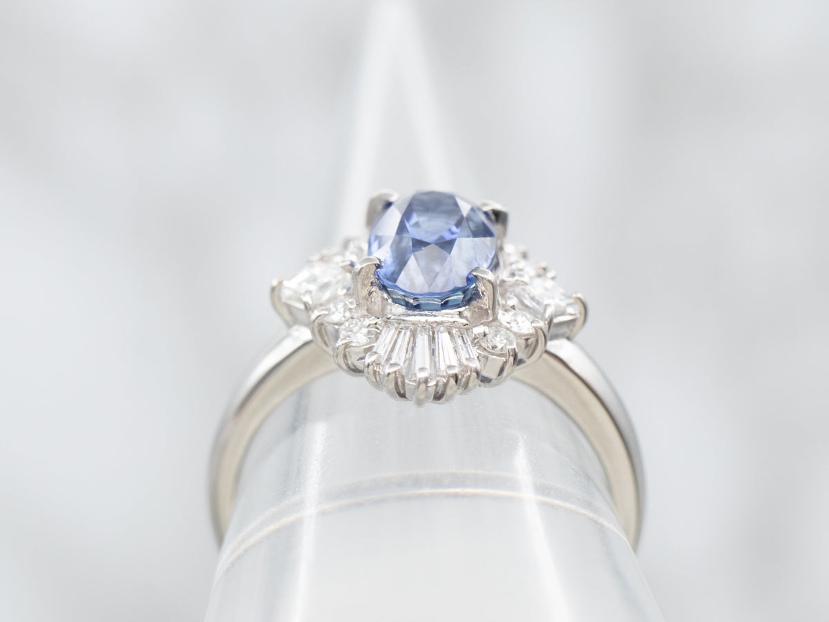 Platinum Oval Cut Sapphire Engagement Ring with Round and Baguette Cut Diamond Halo