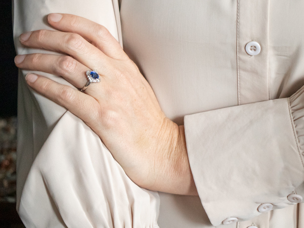 Platinum Oval Cut Sapphire Engagement Ring with Round and Baguette Cut Diamond Halo