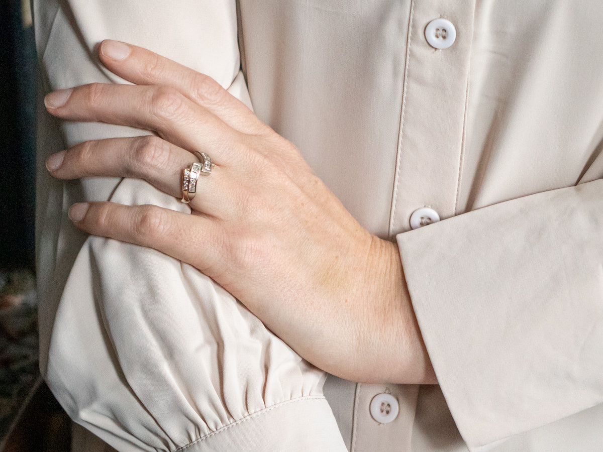 Two Tone Princess Cut Diamond Bypass Ring with Round Cut Diamond Accents