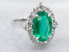 White Gold Oval Cut Emerald Ring with Diamond Halo