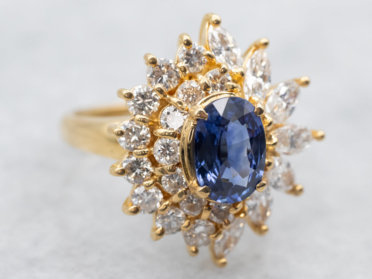 Yellow Gold Oval Cut Sapphire Engagement Ring with Marquise and Round Cut Diamond Halo