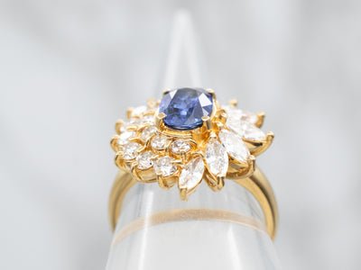 Yellow Gold Oval Cut Sapphire Engagement Ring with Marquise and Round Cut Diamond Halo