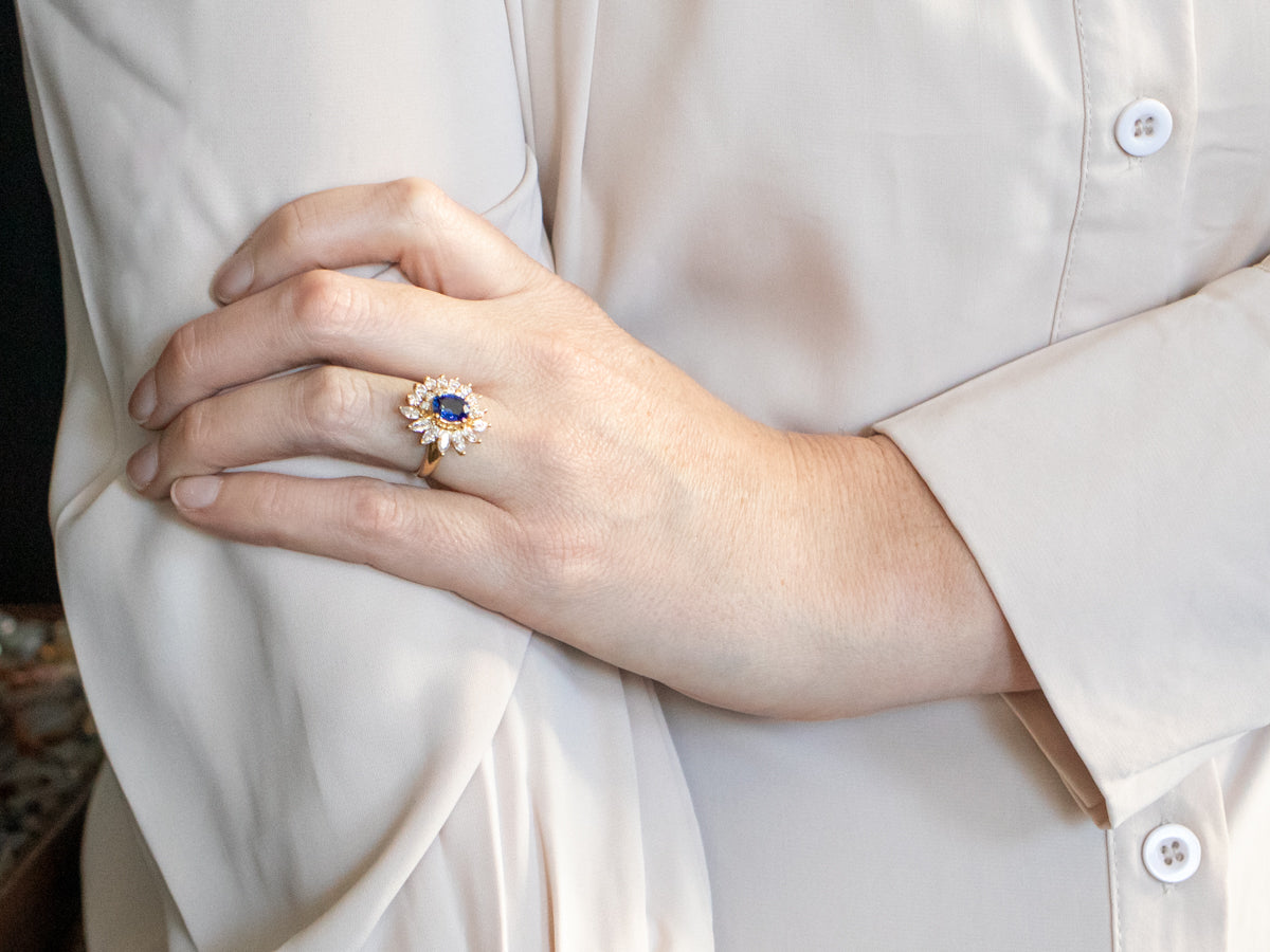 Yellow Gold Oval Cut Sapphire Engagement Ring with Marquise and Round Cut Diamond Halo