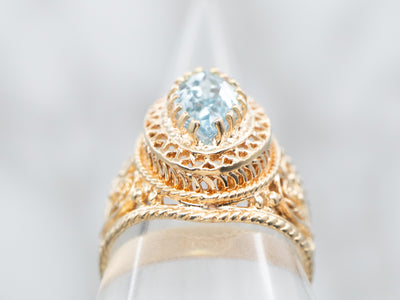Yellow Gold Marquise Cut Blue Topaz Solitaire Ring With Filigree Heart Shoulders