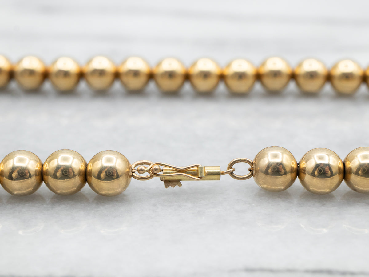 Polished Gold Beaded Necklace with Barrel Clasp