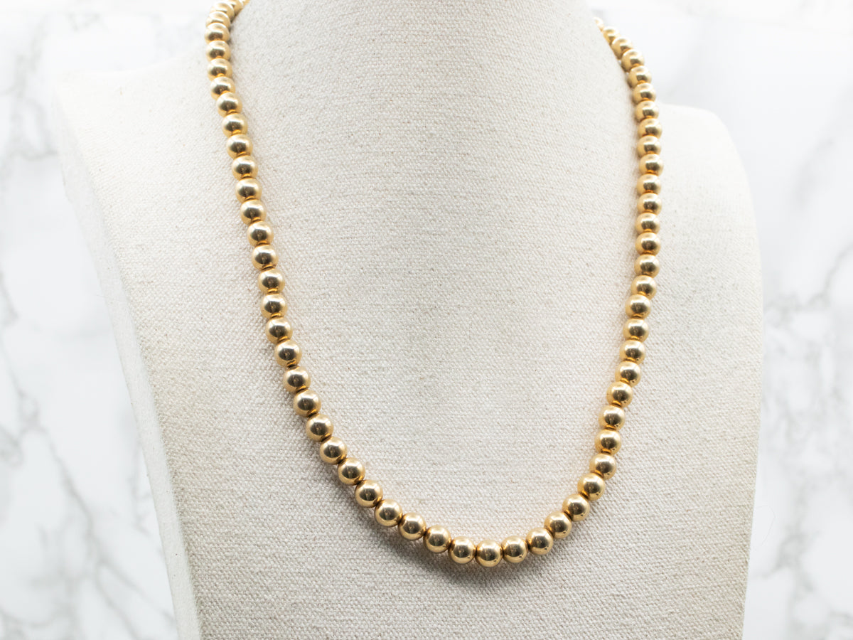 Polished Gold Beaded Necklace with Barrel Clasp