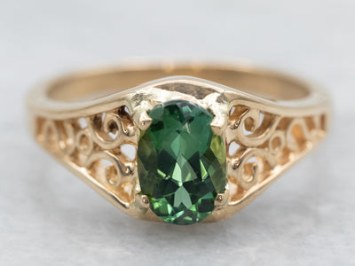 Yellow Gold Oval Cut Green Tourmaline Solitaire Ring with Pierced Scrolling Shoulders