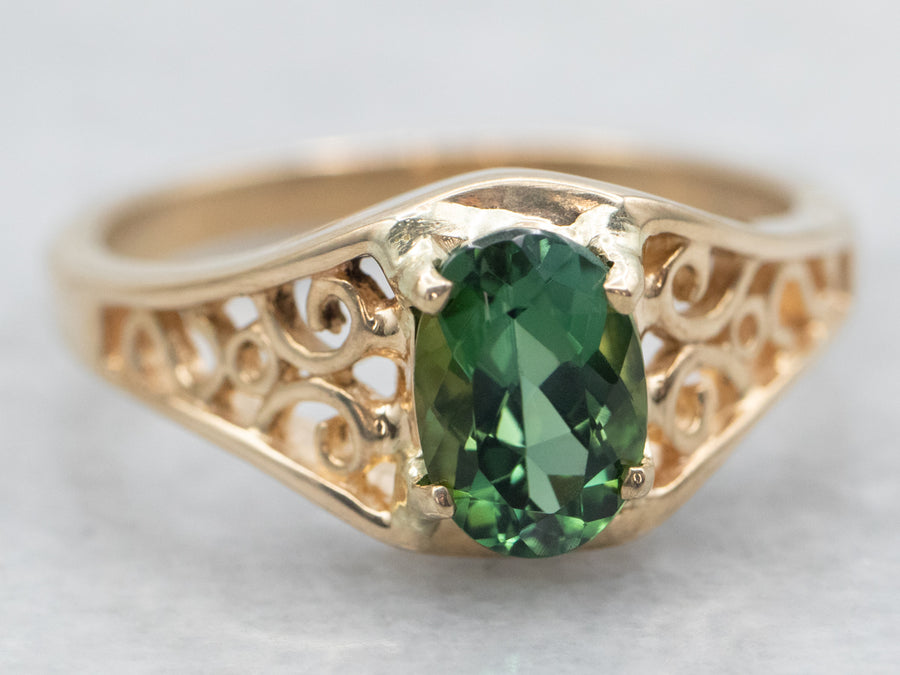 Yellow Gold Oval Cut Green Tourmaline Solitaire Ring with Pierced Scrolling Shoulders