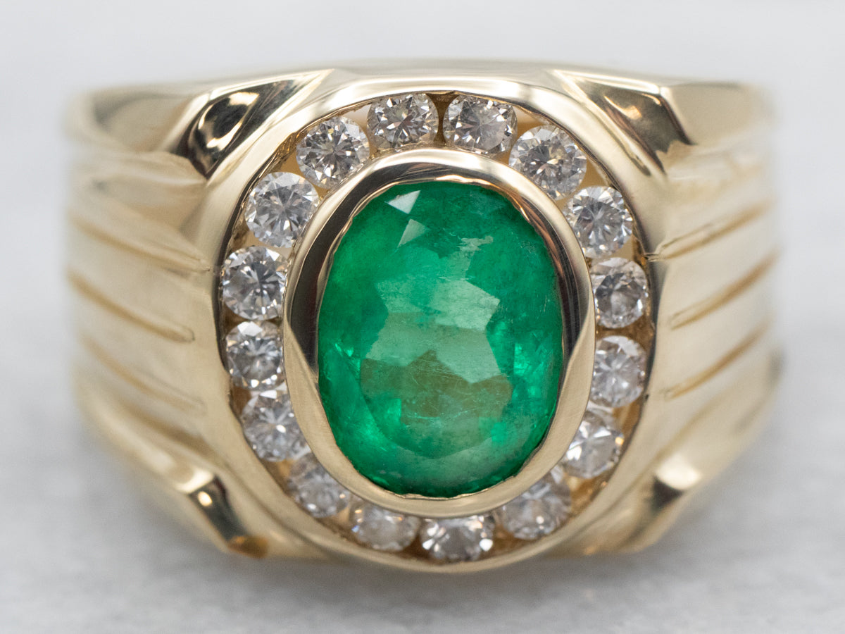 Yellow Gold Bezel Set Oval Cut Emerald Ring with Diamond Halo and Grooved Shoulders