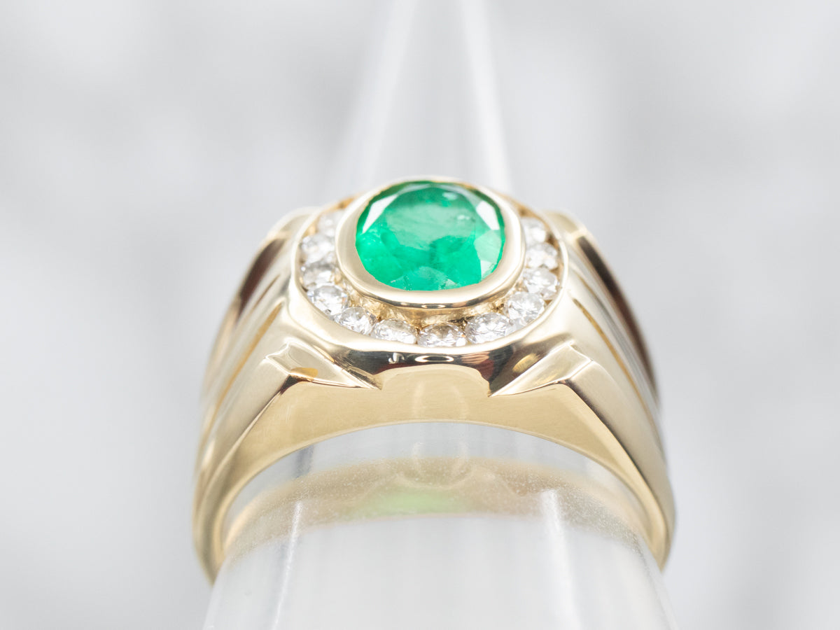 Yellow Gold Bezel Set Oval Cut Emerald Ring with Diamond Halo and Grooved Shoulders