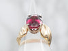 Yellow Gold Oval Cut Rhodolite Garnet Solitaire Ring with Twist Shoulders