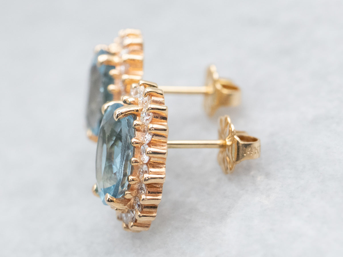 Aretes de topacio azul con halo de diamantes