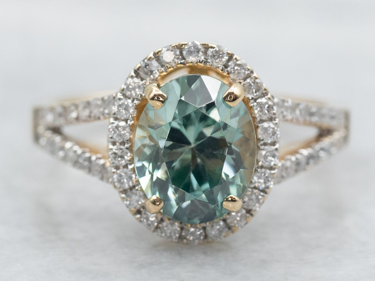 Yellow Gold Oval Cut Blue Zircon Split Shank Ring With Diamond Halo and Diamond Shoulders