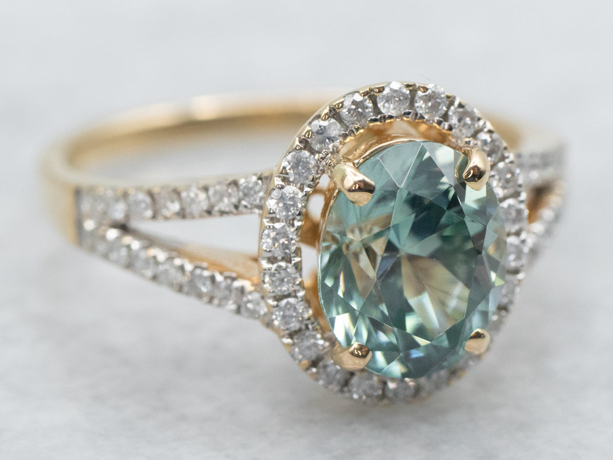 Yellow Gold Oval Cut Blue Zircon Split Shank Ring With Diamond Halo and Diamond Shoulders