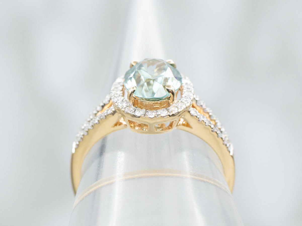 Yellow Gold Oval Cut Blue Zircon Split Shank Ring With Diamond Halo and Diamond Shoulders