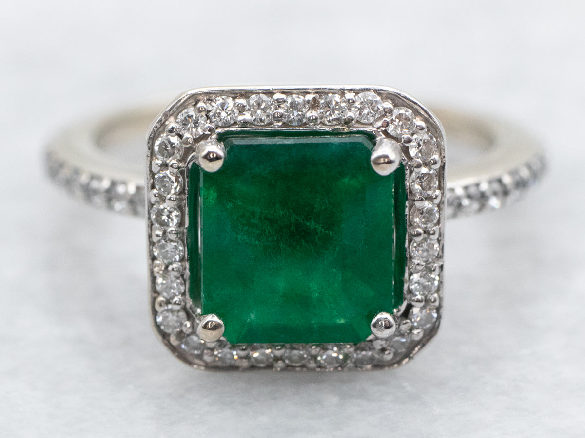 Modern Emerald and Diamond Halo Engagement Ring