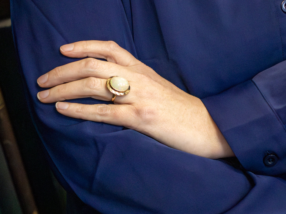 Opal Solitaire Ring with Wave Pattern Frame