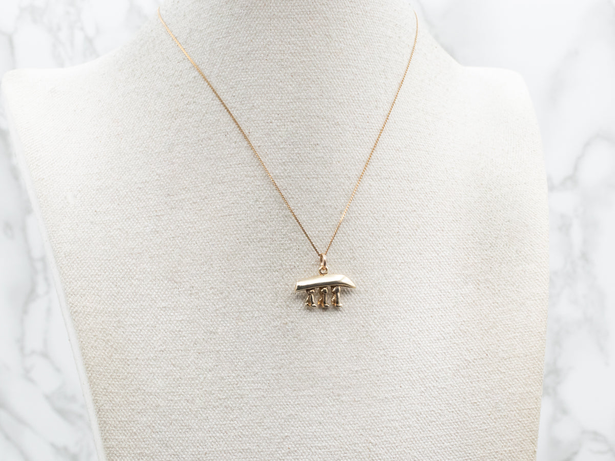 Yellow Gold Canoe Being Carried Pendant