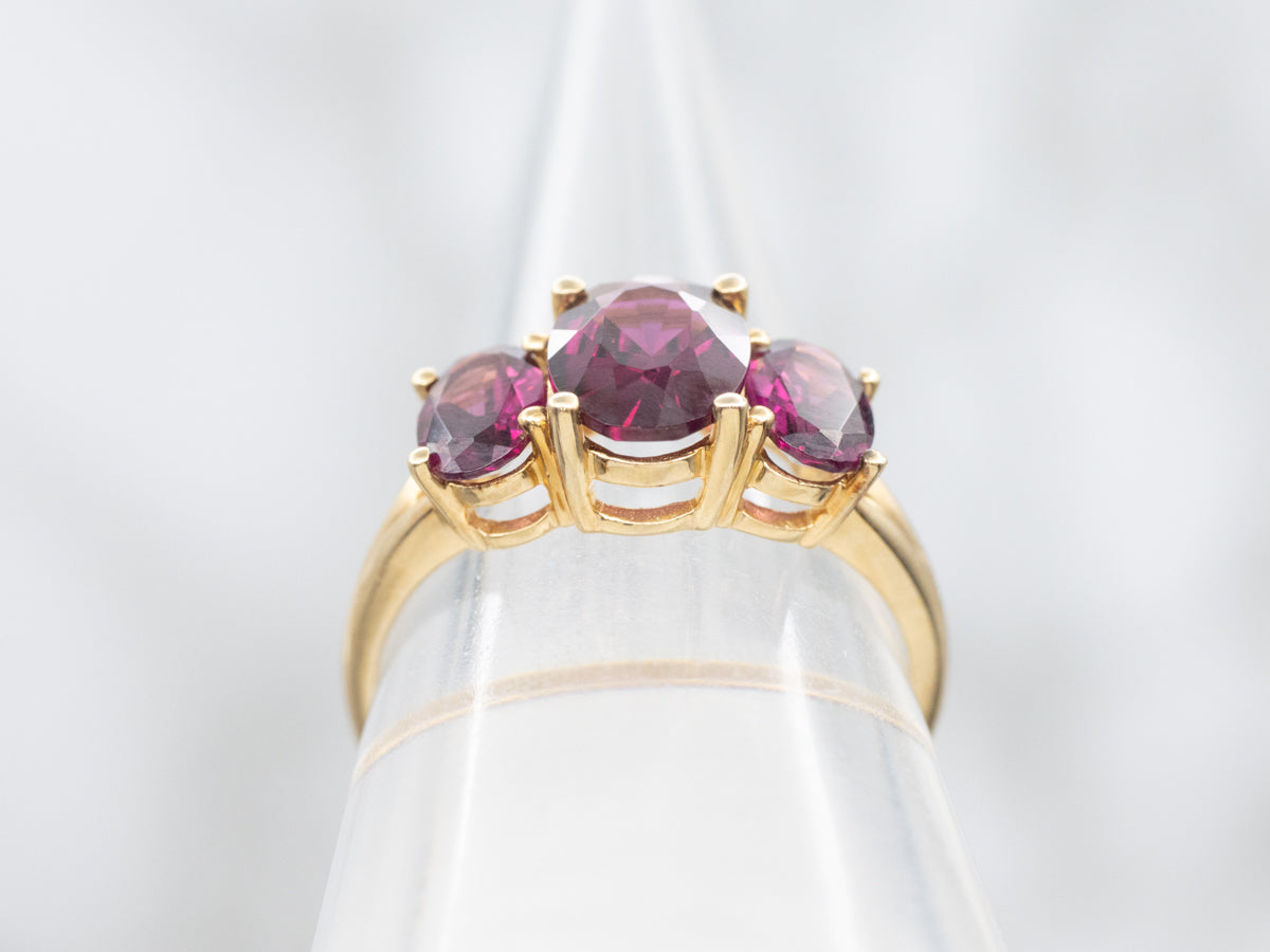 Polished Gold Three Stone Rhodolite Garnet Ring