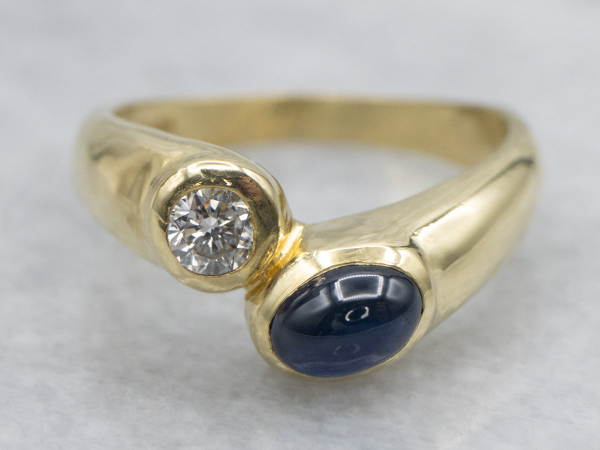Modernist 18-Karat Gold Sapphire Cabochon and Diamond Bypass Ring