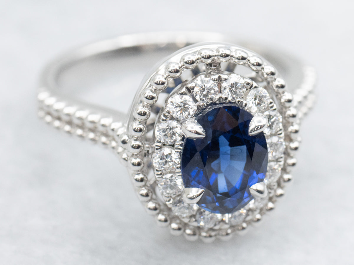 Modern Gold Sapphire and Diamond Halo Ring