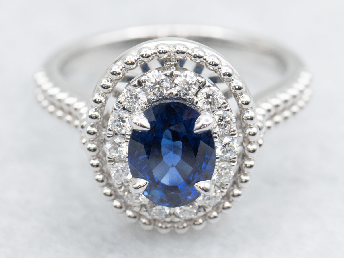 Modern Gold Sapphire and Diamond Halo Ring