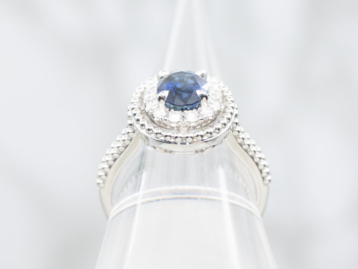 Modern Gold Sapphire and Diamond Halo Ring