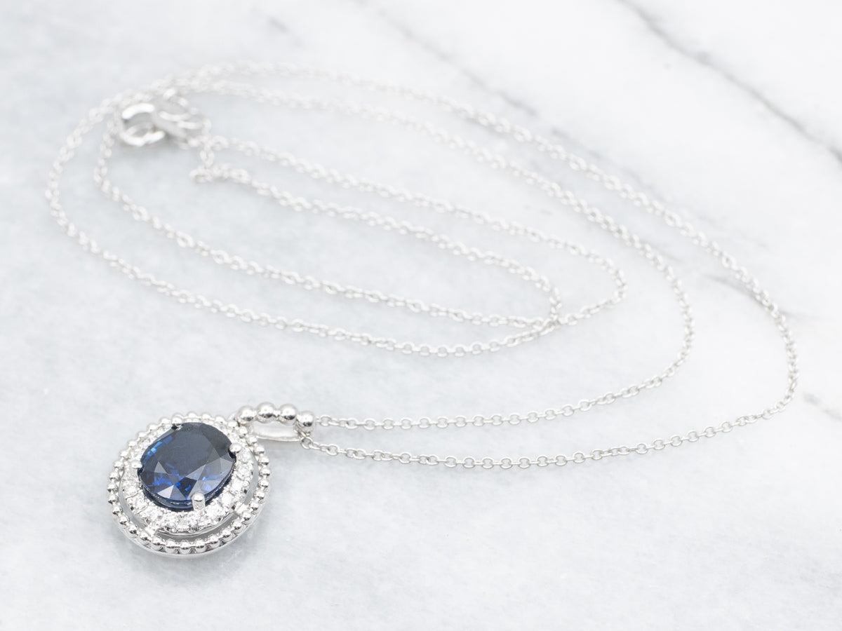 Modern Gold Sapphire and Diamond Halo Pendant Necklace