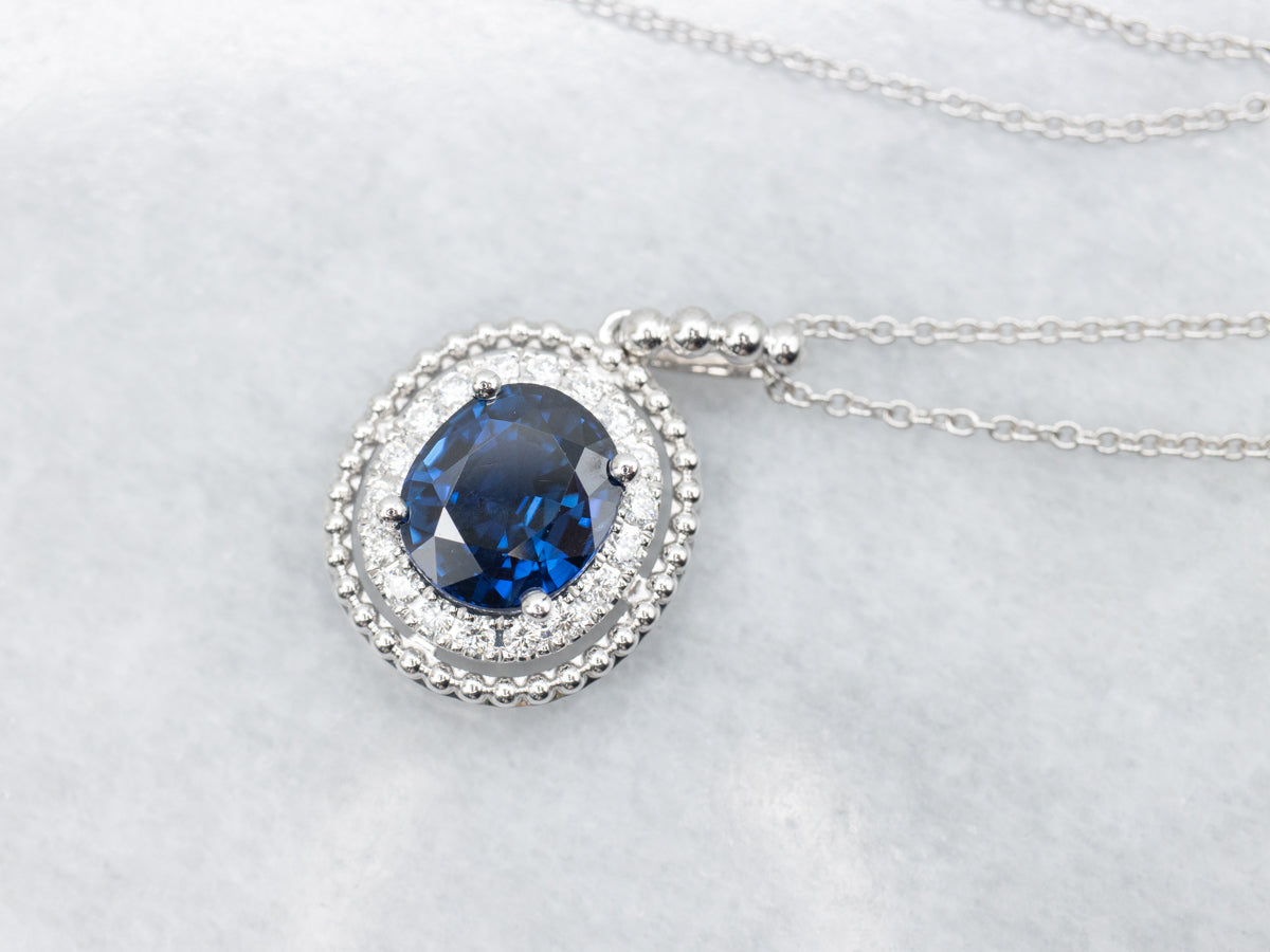 Modern Gold Sapphire and Diamond Halo Pendant Necklace