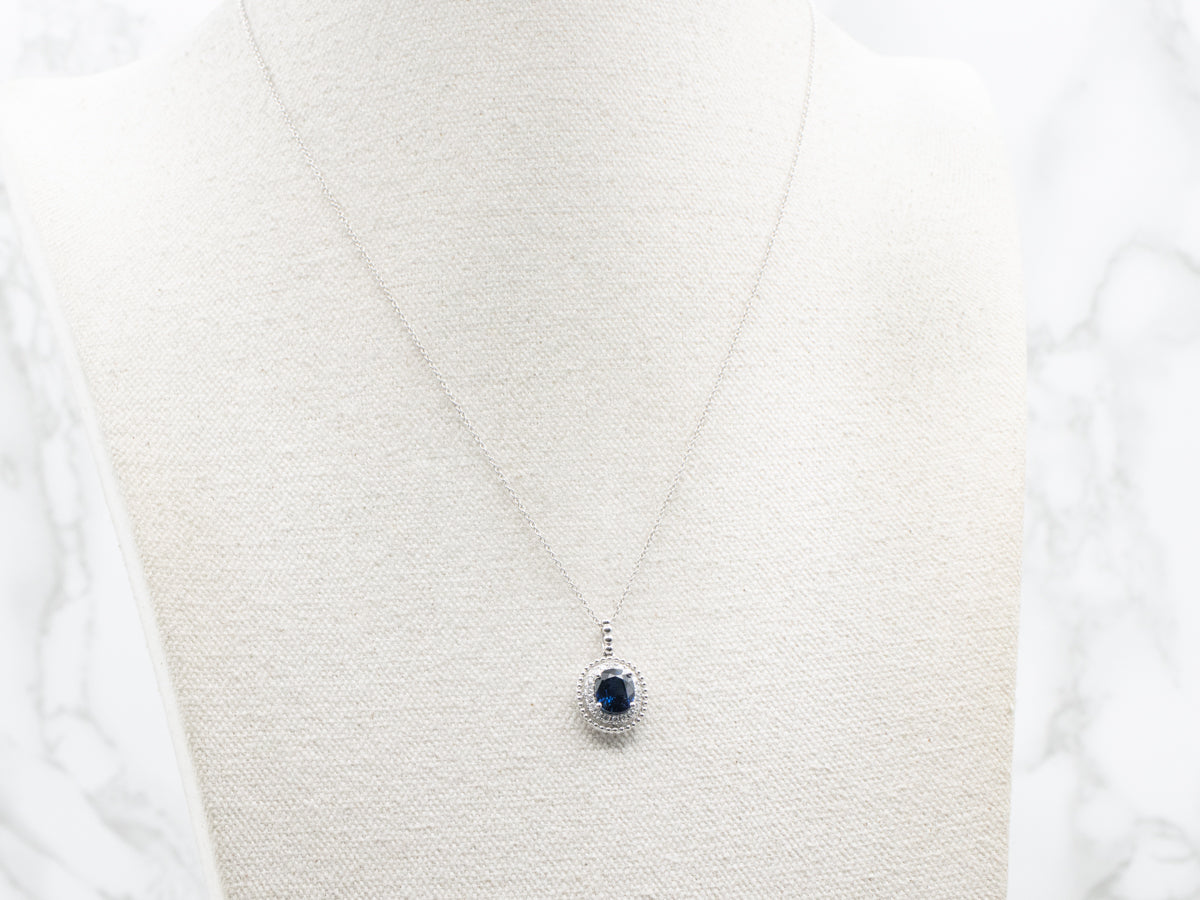 Modern Gold Sapphire and Diamond Halo Pendant Necklace