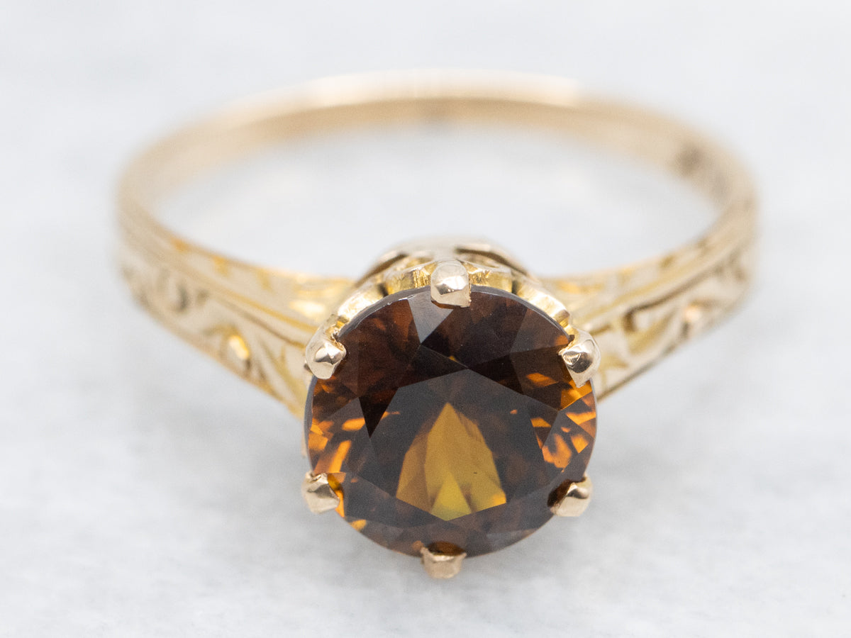Mali Garnet Solitaire Ring with Ornate Gold Shoulders