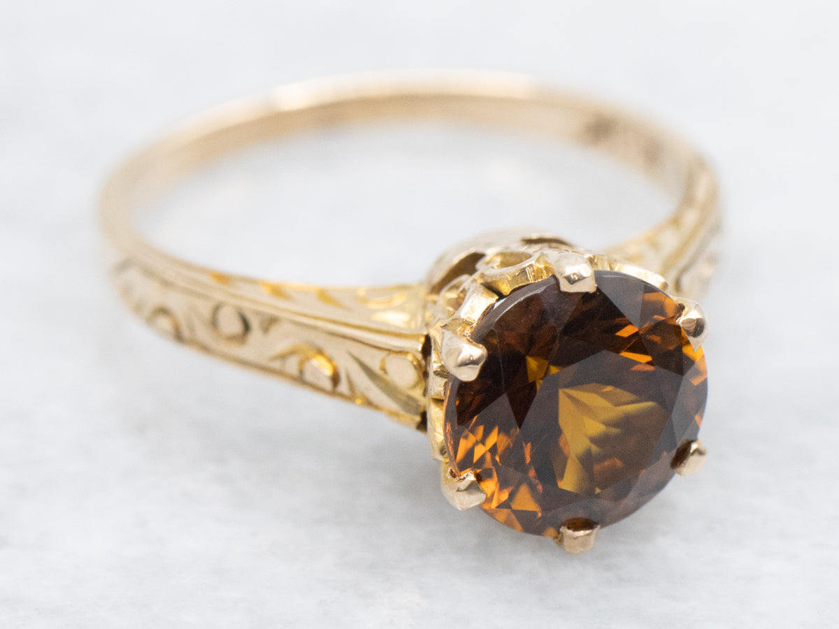 Mali Garnet Solitaire Ring with Ornate Gold Shoulders