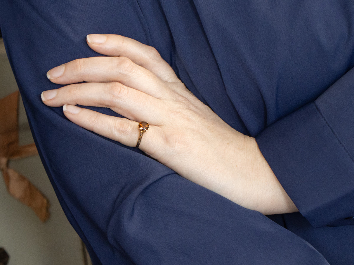 Mali Garnet Solitaire Ring with Ornate Gold Shoulders