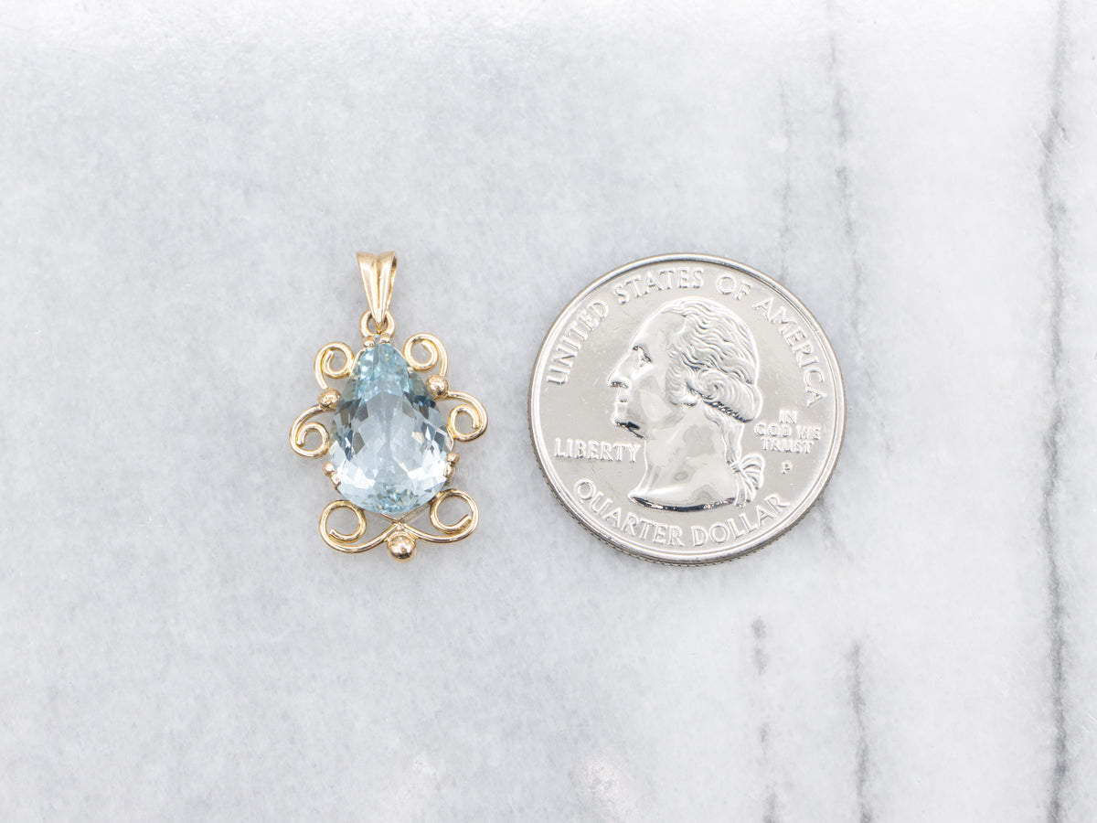Pear Cut Aquamarine Pendant in Scrolling Gold Frame