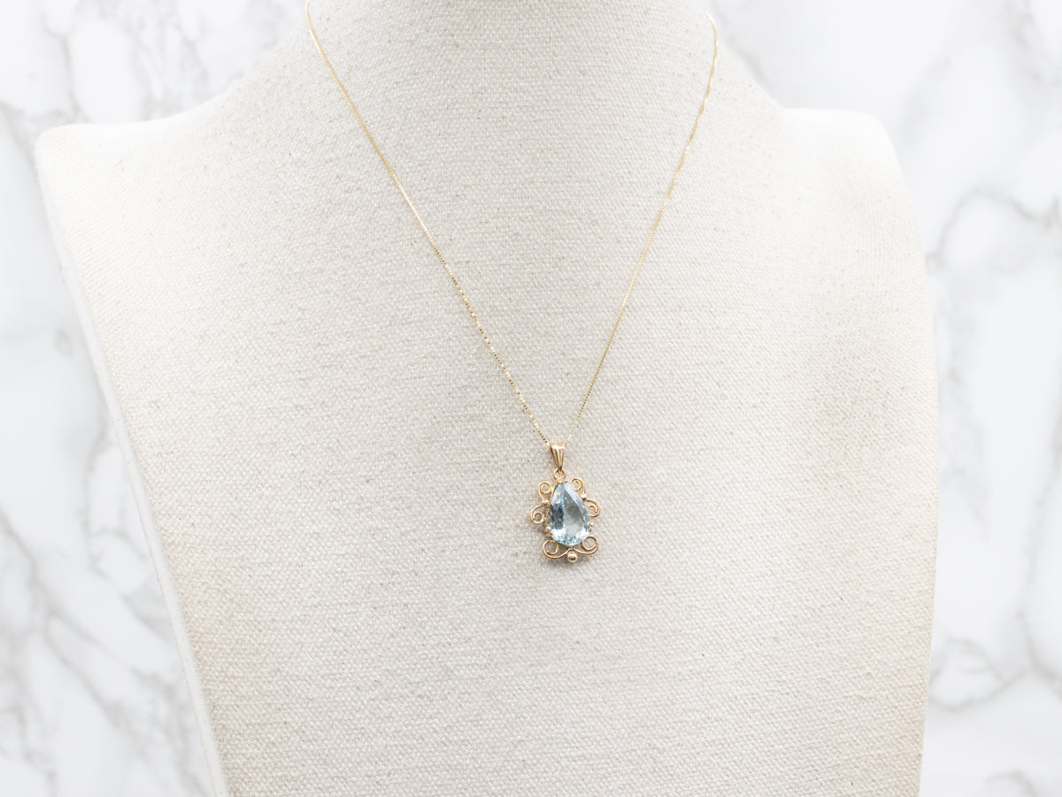 Pear Cut Aquamarine Pendant in Scrolling Gold Frame