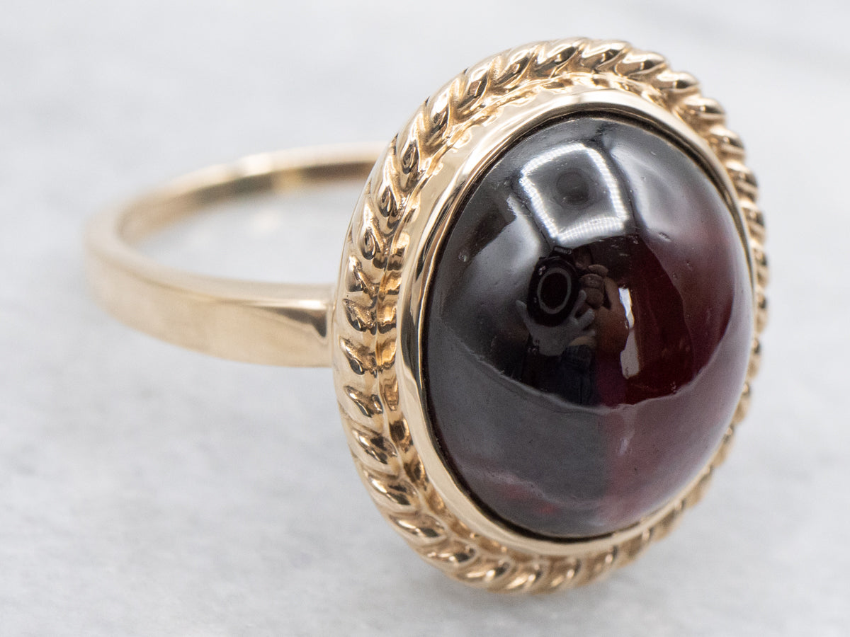 Garnet Cabochon Ring with Twisted Frame