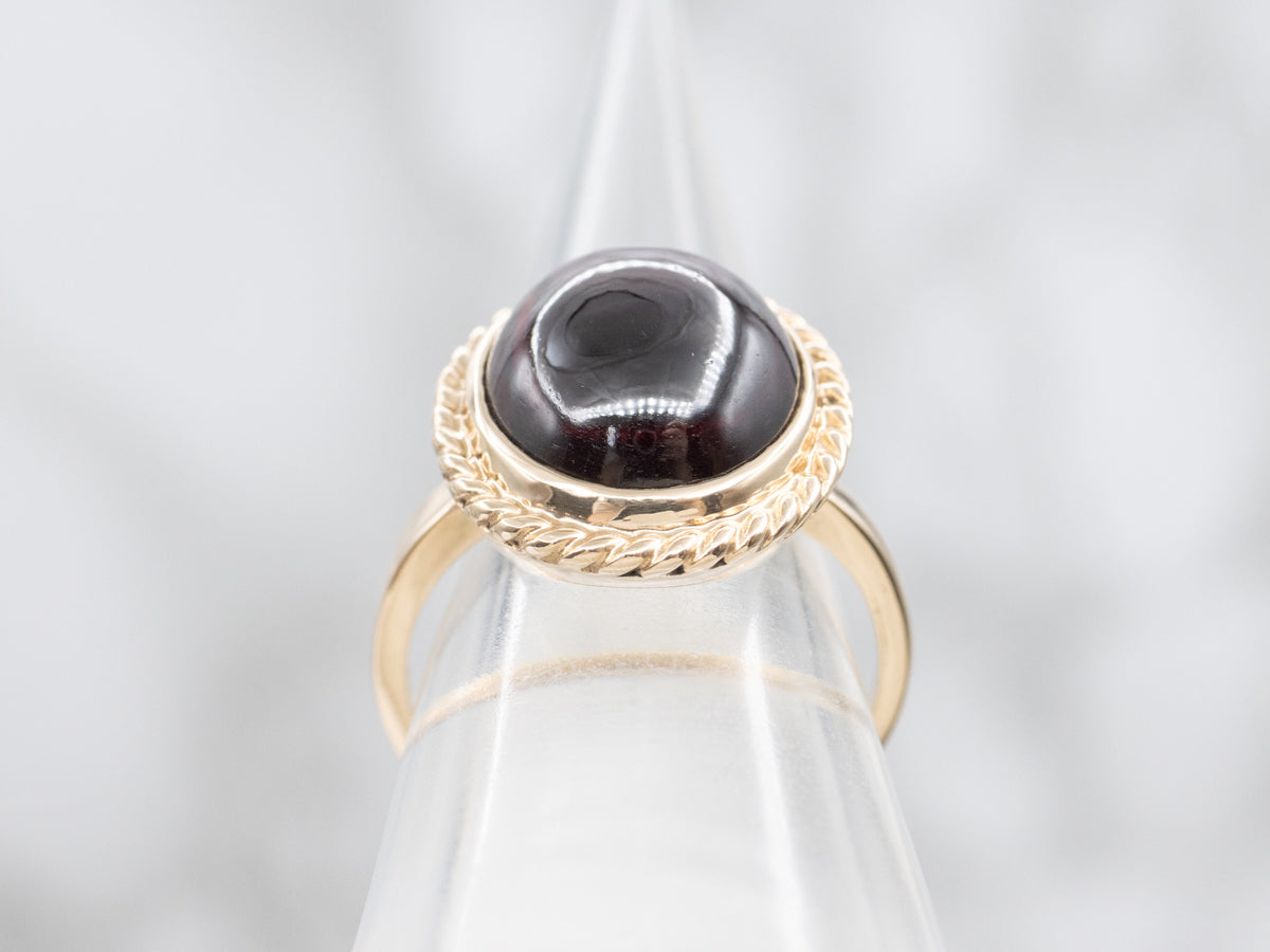 Garnet Cabochon Ring with Twisted Frame